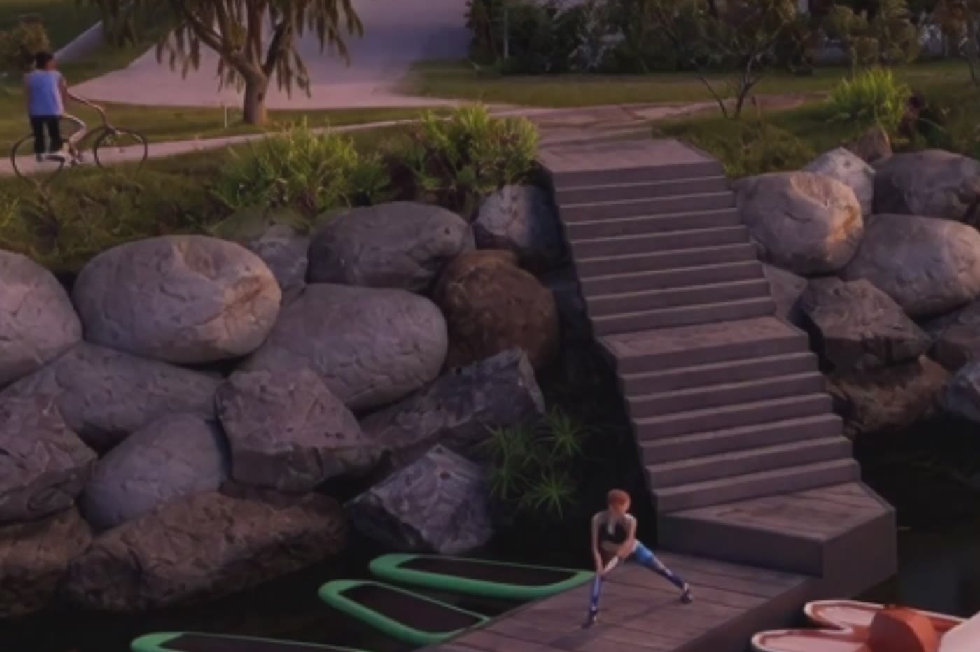 Kamienne schody na brzeg o zmierzchu, głazy nad wodą, rowerzysta na ścieżce powyżej